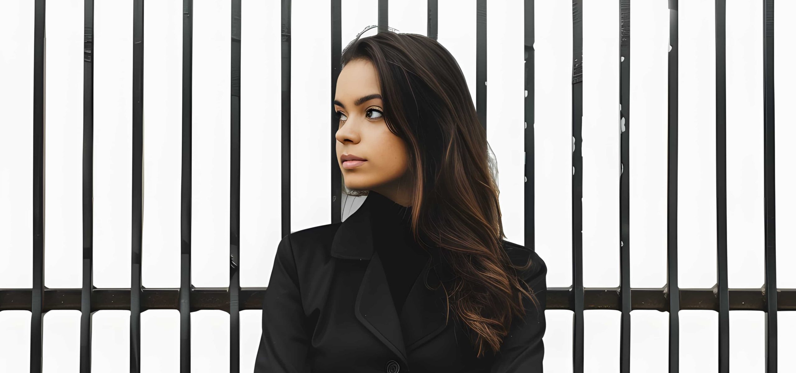 woman-standing-front-metal-fence-isolated-white-background-min-min